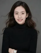 Jieyi Deng, in a black turtleneck against a plain grey background.